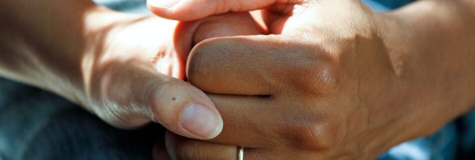 person wearing gold wedding band
